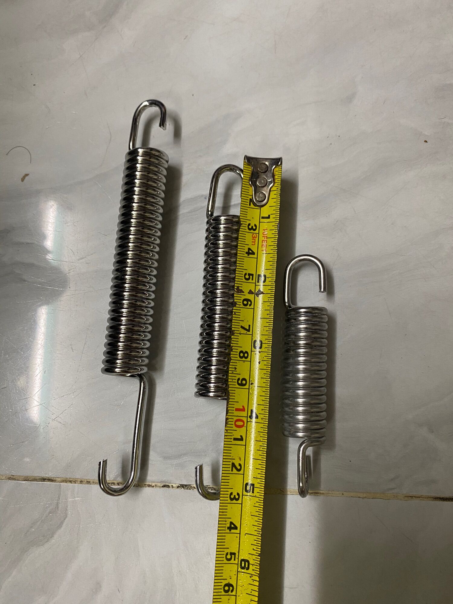 lò xo chống đứng inox gắn xe máy