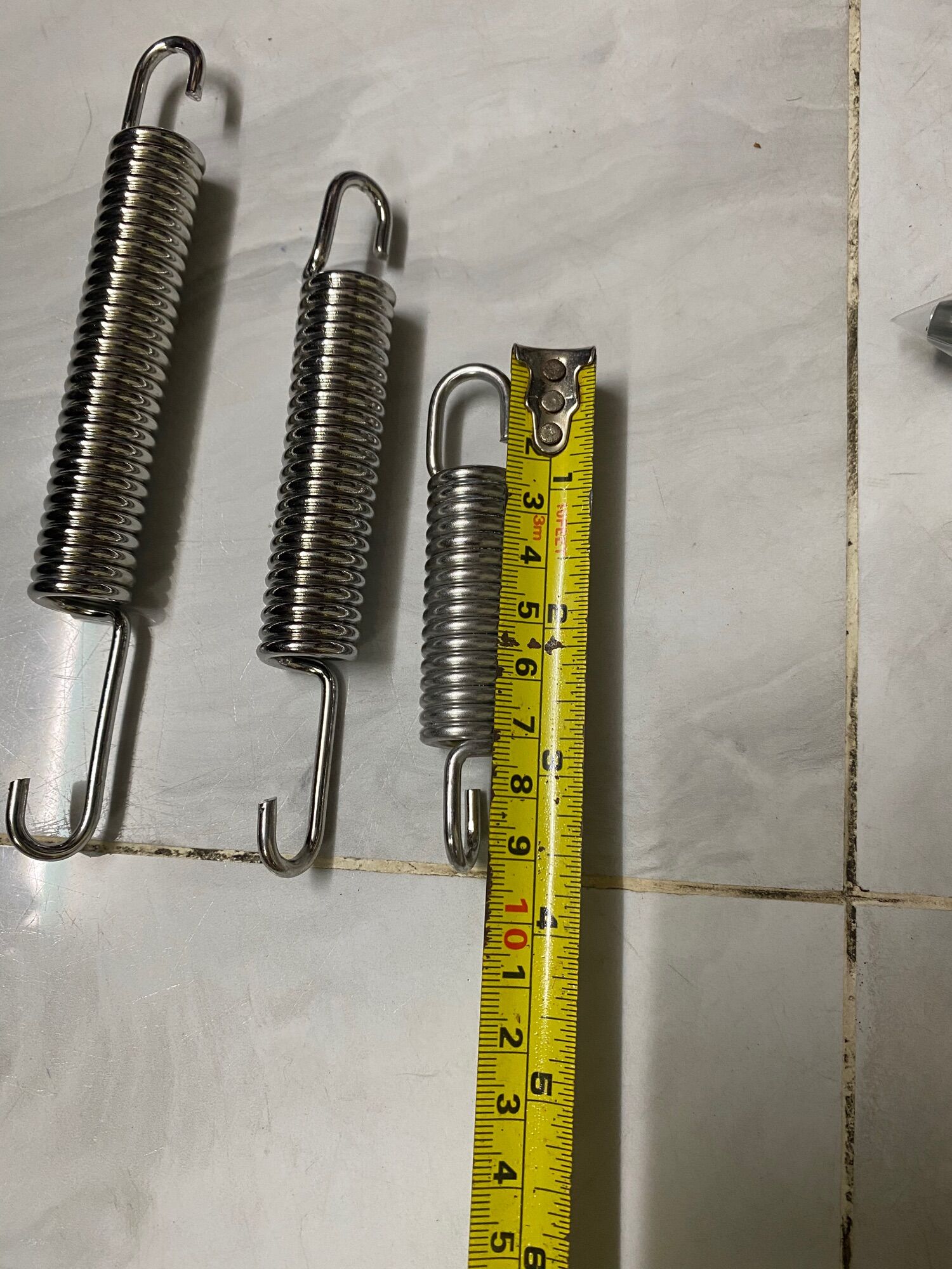 lò xo chống đứng inox gắn xe máy