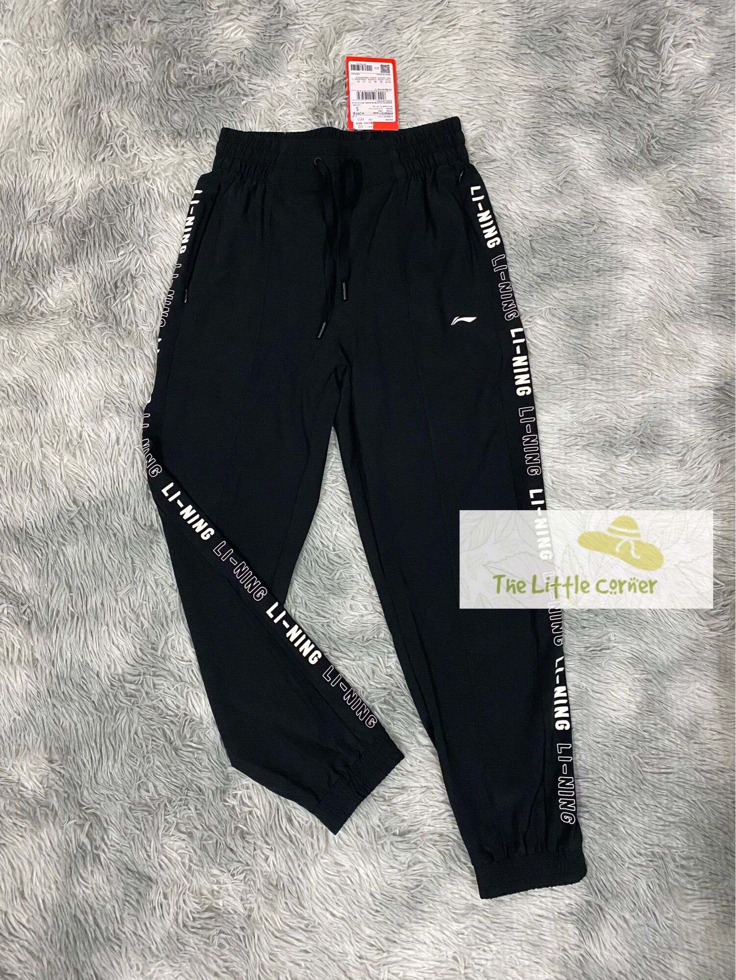 Quần gió thể thao nữ Lining AYKS512-1
