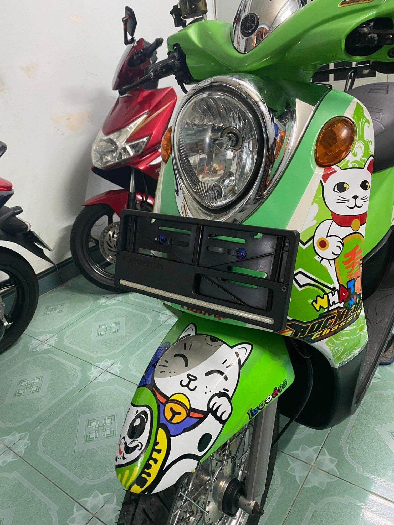 Tem xe Mio classico . Tem mèo thần tài có đủ màu