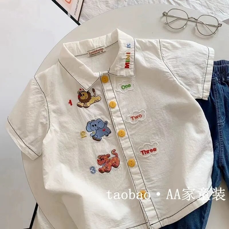 Áo Sơ Mi Trẻ Em Mùa Hè Màu Trắng Thêu Họa Tiết Hoạt Hình Cổ Bẻ Tay Ngắn Vải Cotton Pha Polyester Áo 