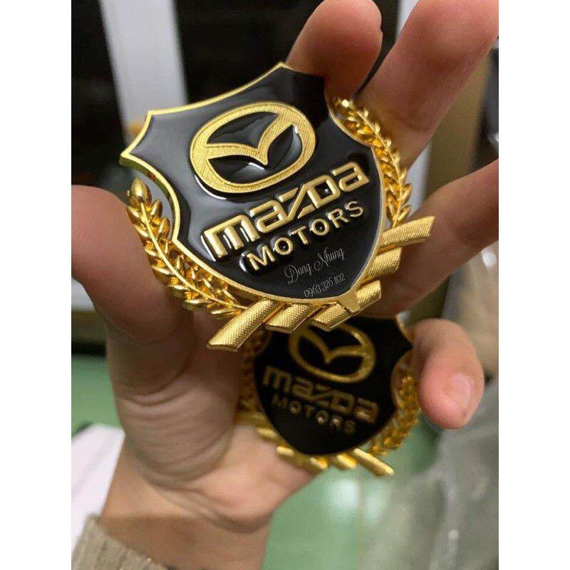 logo bông lúa chất liệu hợp kim đồng hãng xe MAZDA