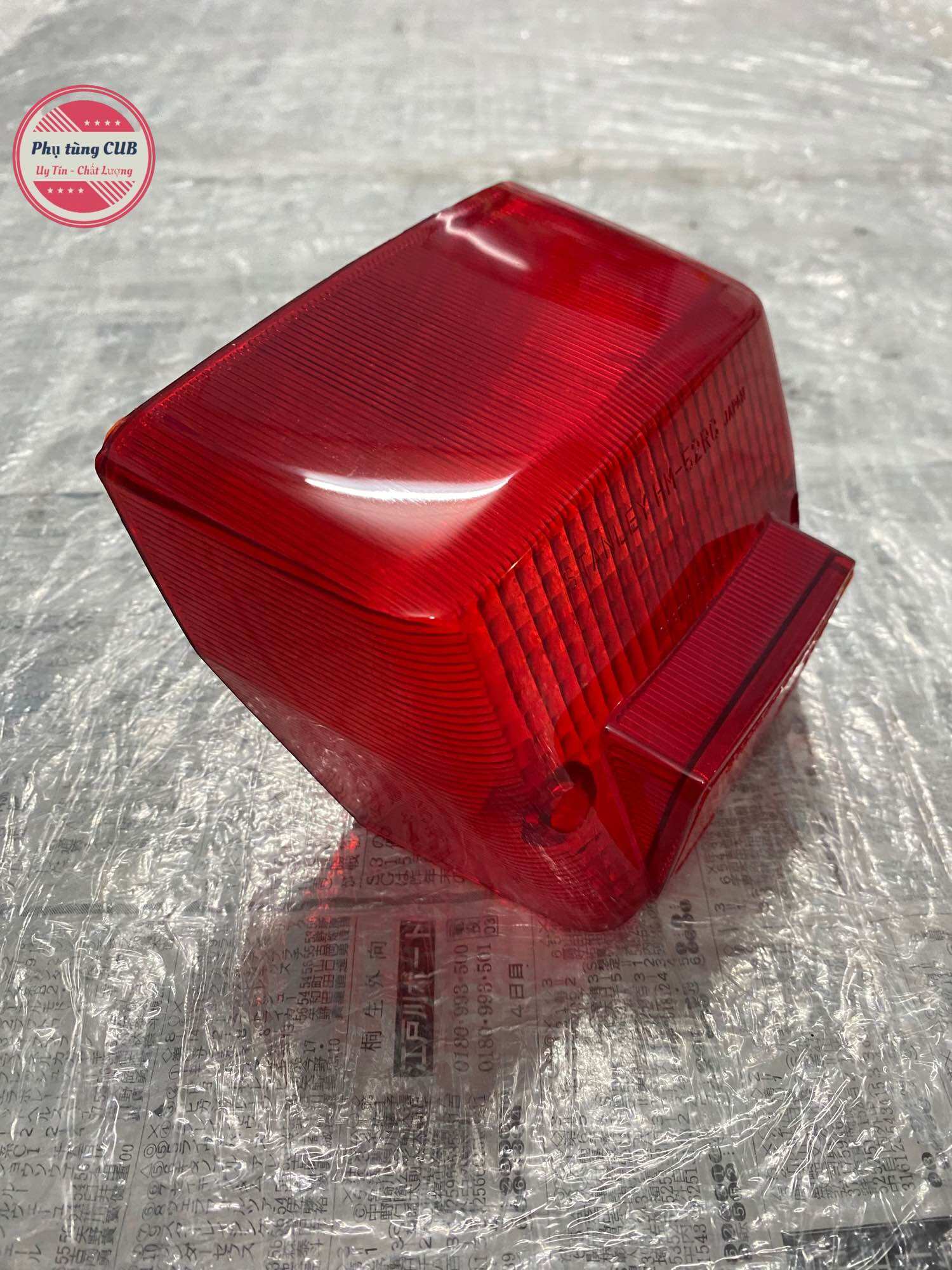 Chụp đèn hậu xe cub 82-84-DD hàng zin mới
